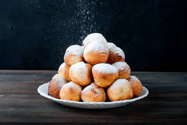 istock donuts laid out pyramid sprinkled with powdered sugar 690397804