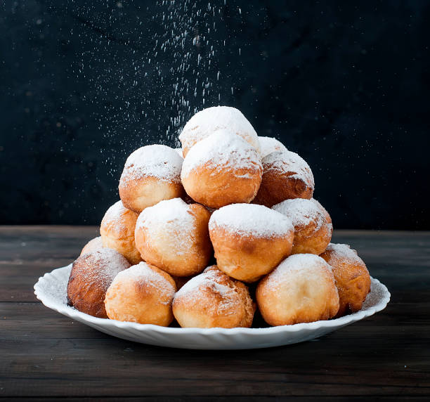 istock donuts laid out pyramid sprinkled with powdered sugar 690397852