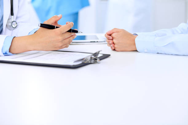 istock Doctor and patient are discussing something, just hands at the table 690400934
