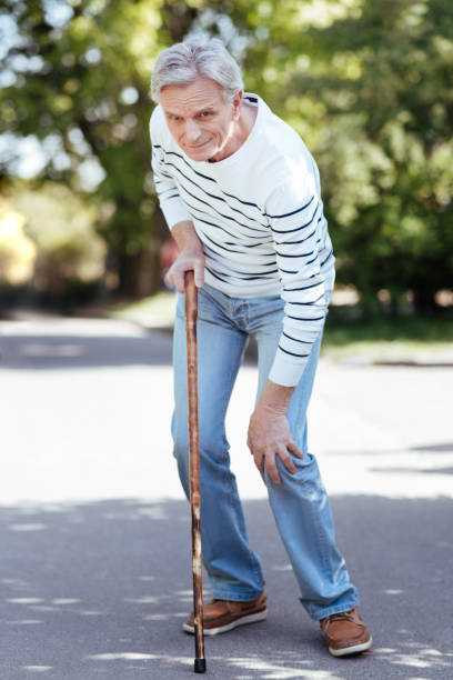 istock Confused pensioner feeling ache in knee outdoors 690401194
