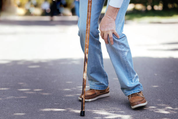 istock Ill aged man touching ill knee outdoors 690401226