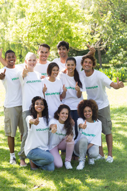 istock Volunteers showing thumbs up in park 690403646