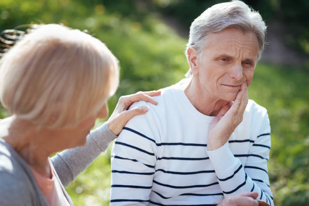 istock Depressed pensioner having toothache outdoors 690403722