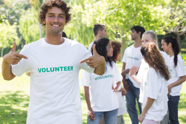 istock Portrait of volunteer pointing at tshirt 690403830