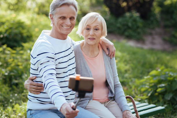 istock Retired couple enjoying modern technologies outdoors 690404084