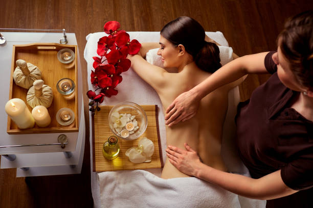 istock Young woman in spa massage salon. Top view 690406972