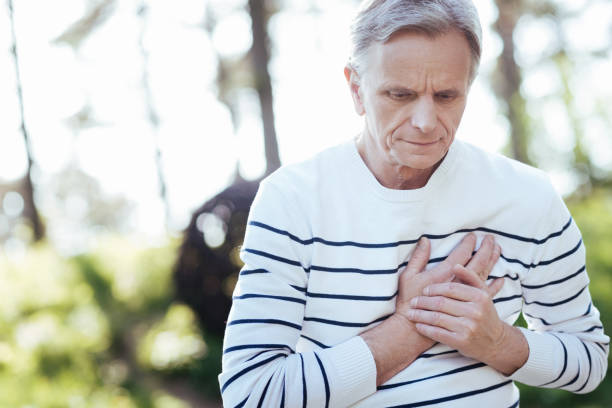 istock Overwhelmed pensioner suffering from heart attack outdoors 690406978