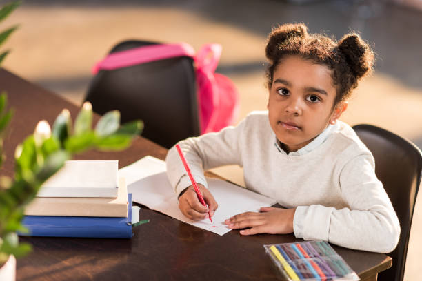 istock african american schoolgirl doing homework, african student concept 690411120