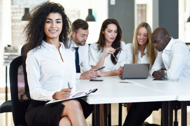 istock Multi-ethnic group of three businesspeople meeting in a modern office. 690411504