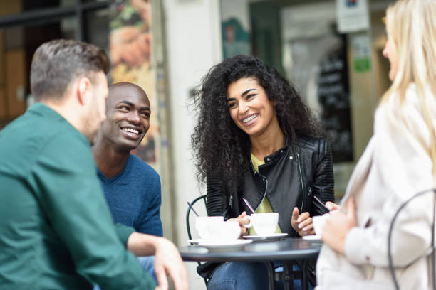 istock Multiracial group of four friends having a coffee together 690416086