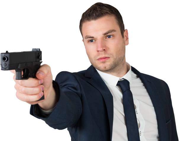 istock Serious businessman pointing a gun 690419044