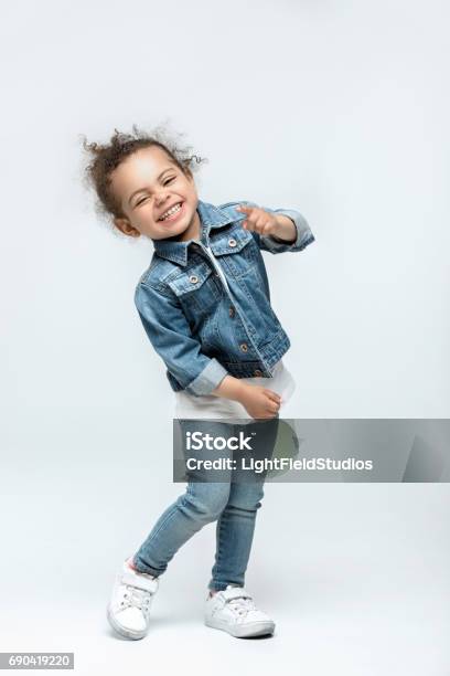 Funny Little Kid Girl In Jeans Isolated On White Stock Photo - Download Image Now - Child, White Background, Cut Out