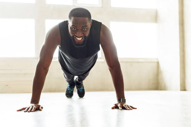 istock Cheerful african sportsman performing power load exercises 690419378