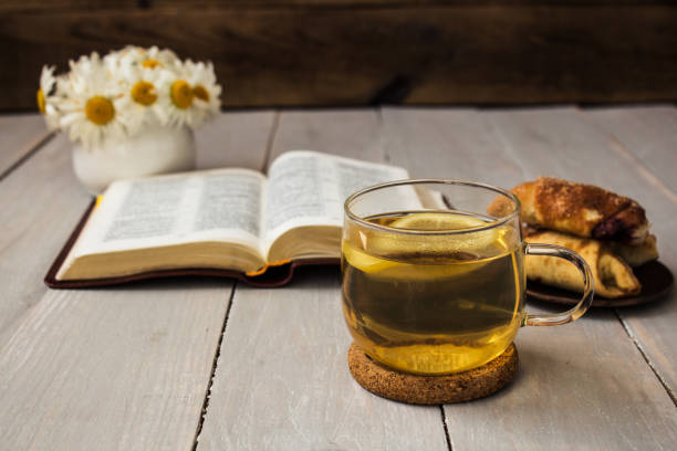 istock bible and tea on wooden background 690419940