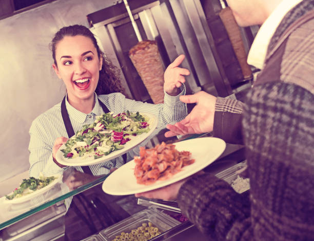 istock Happy adult  female worker serving customer 690423266