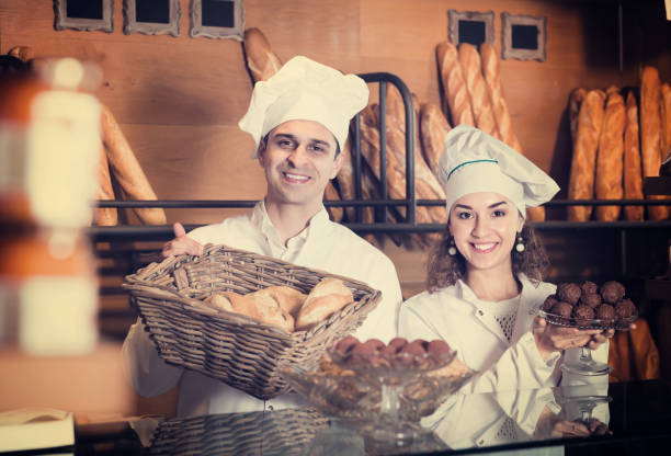 istock Man and woman bakers in bakery 690423326