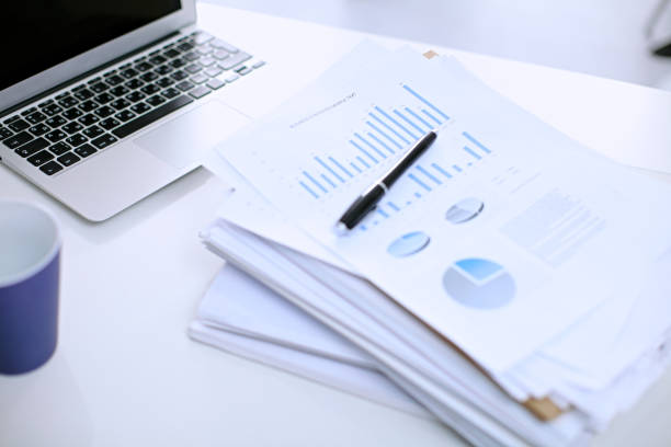 istock Office workplace with a laptop and financial documents 690428102