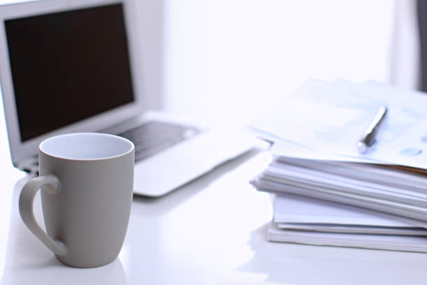 istock Office workplace with a laptop and financial documents 690428258