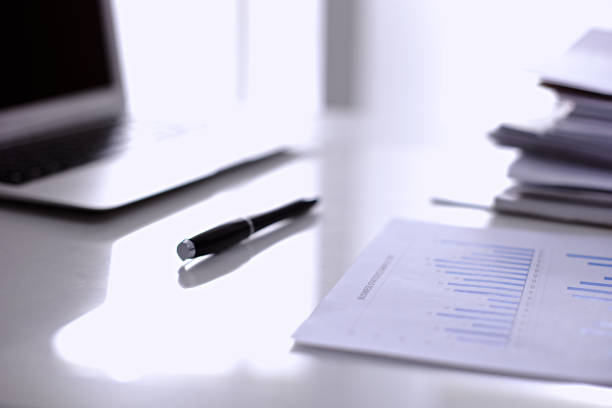 istock Office workplace with a laptop and financial documents 690428670