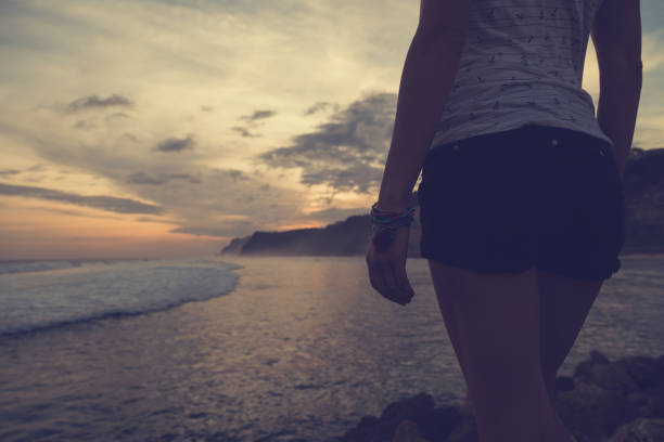 Woman enjoying beautiful sunset on the beach.
