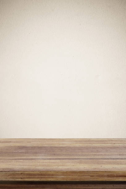 istock Empty wooden table over brown cement wall  background, for product display montage 690432220