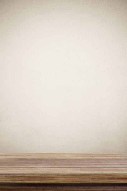 Empty wooden table over brown cement wall  background, for product display montage