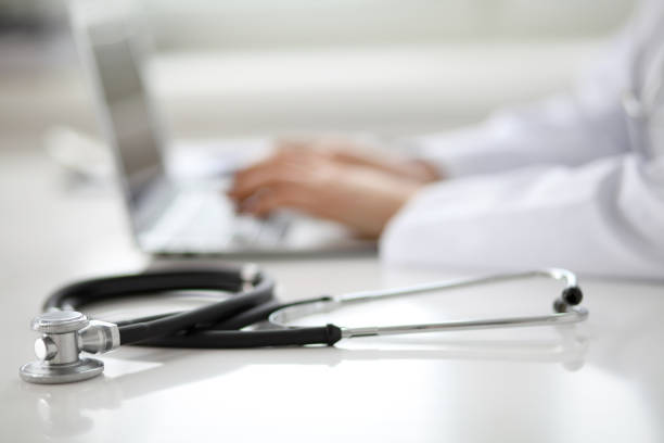 istock Female doctor typing on laptop, close up 690433020