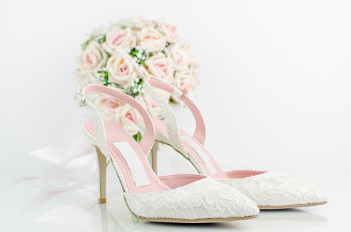 Wedding Bridal Shoes With Pink Roses Flower Bouquet On White Background With Reflection