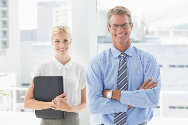 istock Smiling business partners looking at camera 690444334