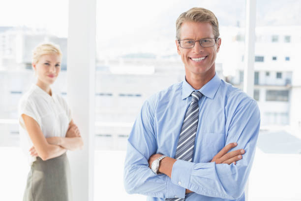 istock Smiling business partners looking at camera 690444412