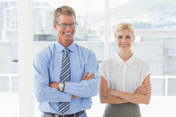 istock Smiling business partners looking at camera 690444884