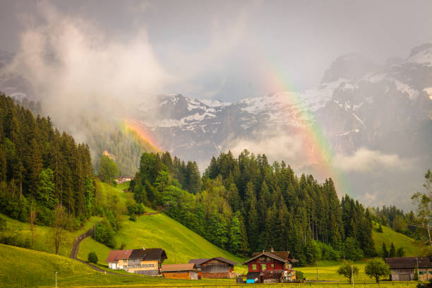 two rainbows in the obersimmental, switzerland - wildstrubel imagens e fotografias de stock