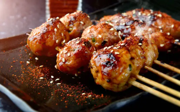 japanese meatball grill  or tsukune cooked with teriyaki sauce ready to eat photo in studio lighting.