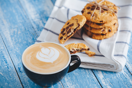 Coffee with Chocolate chip cookies on wooden table
