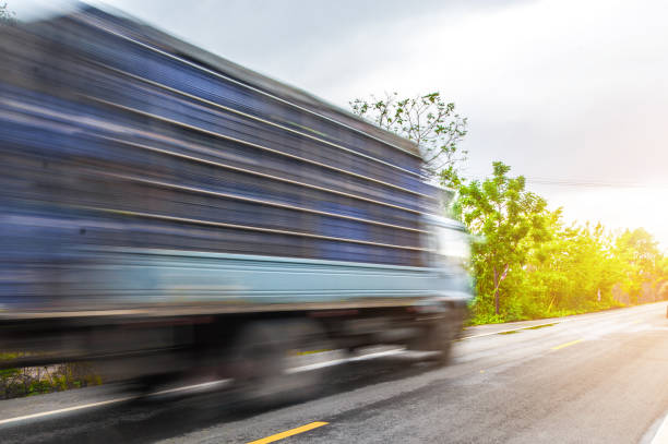 istock Car driving on freeway at asphalt road through the green field 690457750