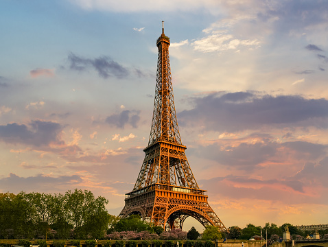 Eiffel Tower against the sky with clouds in springtime on the sunset in Paris, France