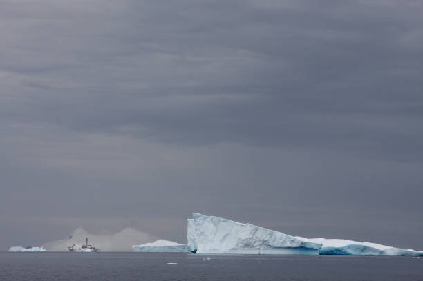 istock huge glassier with a scientific boat next to it during antarctic summer 690458128
