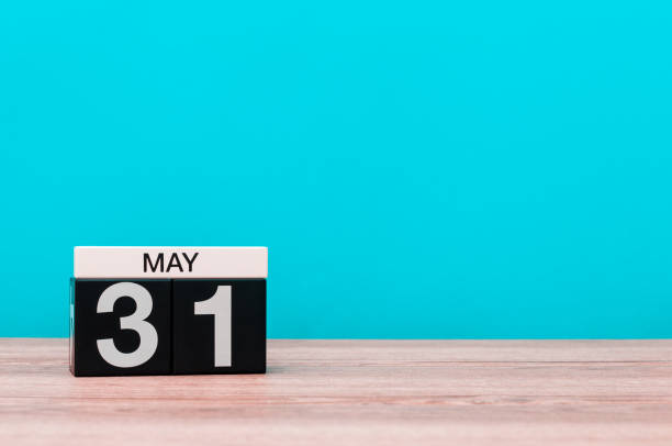 istock May 31st. Day 31 of month, calendar on turquoise background. Spring time, empty space for text 690467794