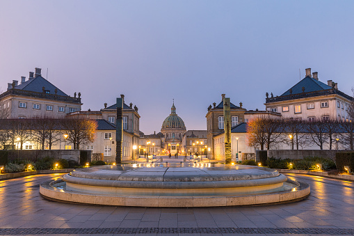 Amalienborg, royal danidh family resident, with town square in Copenhagen denmarkCOPENHAGEN, DENMARK - FEB 26: Night scene of Amalienborg, royal danidh family resident, Copenhagen Denmark on Feb 26, 2017. It consists of four identical classical palace façades with rococo interiors around an octagonal courtyard