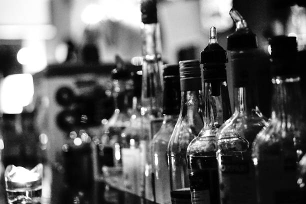 Spirits in a bar spirituous beverages at a bar in black and white liquor store counter photos stock pictures, royalty-free photos & images
