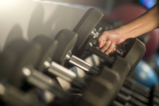 istock Muscular builder man training his body with dumbbell 690470728