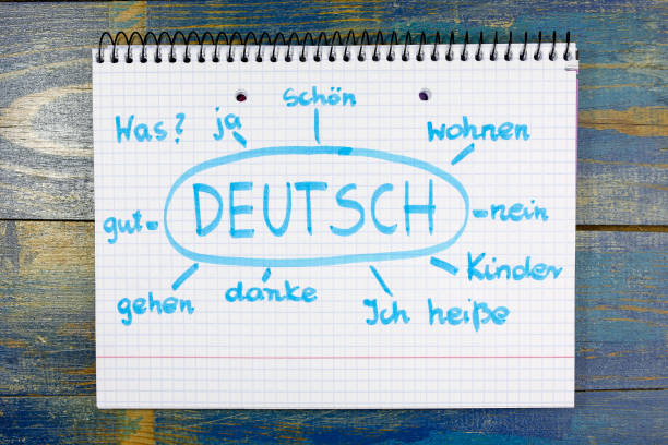 concept of learning german (deutsch) language concept of learning german (deutsch) language. basic vocabulary written in notebook on wooden background german language photos stock pictures, royalty-free photos & images