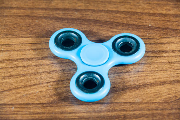 istock Spinner toy in wooden isolated background 690475030