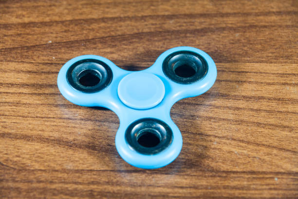 istock Spinner toy in wooden isolated background 690476726