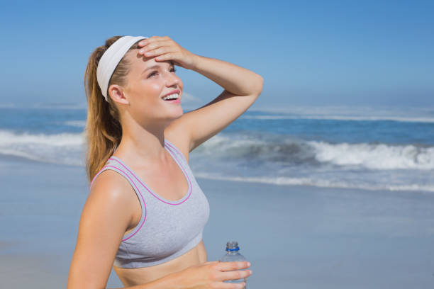 istock Sporty happy blonde standing on the beach 690479004
