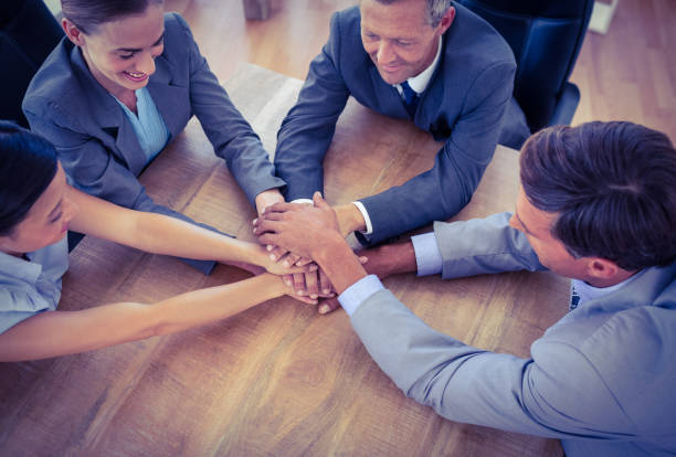 istock Business people joining hands in a circle 690482044