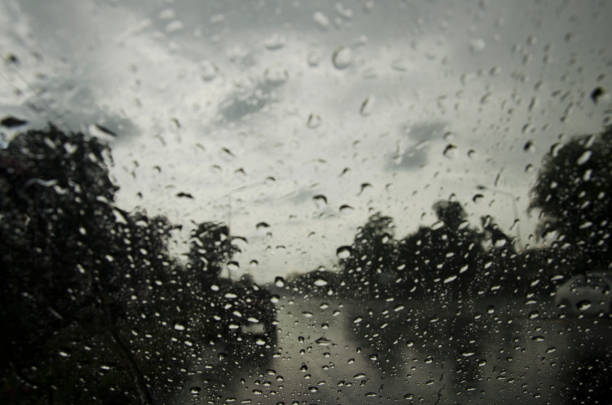 istock Raindrop on glass front of my car stop beside road 690483330