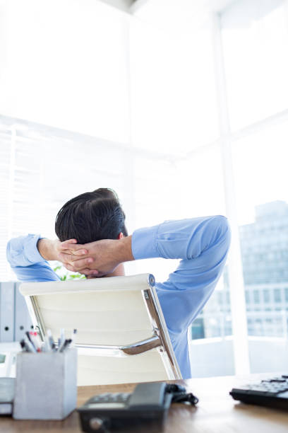 istock Thoughtful businessman at office desk 690486678