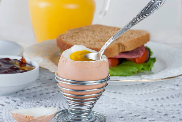 Healthy breakfast with egg , sandviches, toast, jam and juce