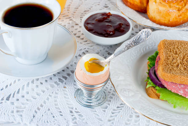Healthy breakfast with egg , sandviches, toast, jam and juce